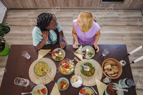 Preview: Two friends enjoy a vibrant dinner party at home together
