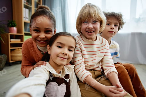 Preview: Diverse group of little children taking selfie photo and smiling at camera