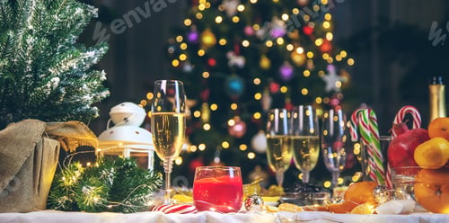 Preview: Christmas table with champagne and food. Selective focus.