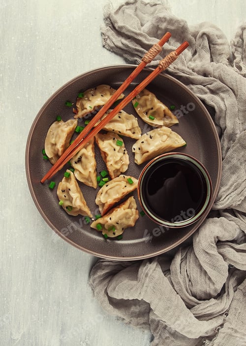 Preview: Japanese Gyoza dumplings,fried, with sauce, top view, without people, tinted, selective focus,