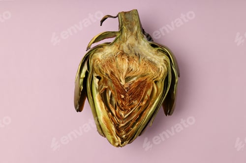 Preview: Grilled artichoke on violet background, close up
