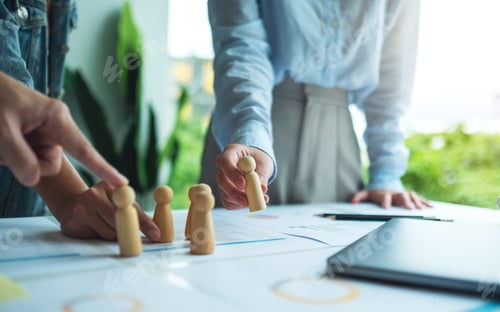 Preview: Business team brainstorming and planning strategy together withwooden people