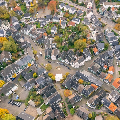 Preview: Aerial shot of a neighborhood with residential buildings and decorative vegetation