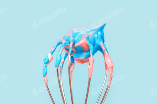 Preview: Whisk with whipped cream from proteins close-up on blue background.