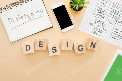 Preview: top view of gadgets near wooden blocks with design lettering, website design template, notebook with