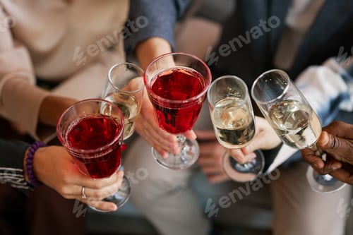 Preview: Close-up of wineglasses and flutes with alcohol in hands of young friends