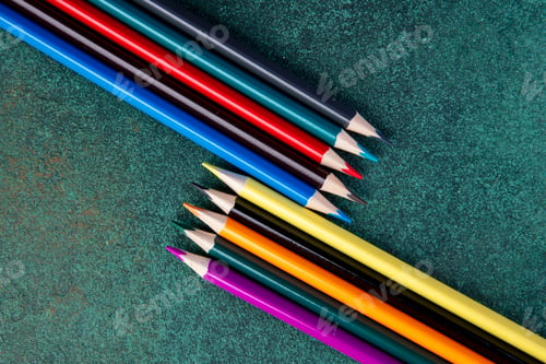Preview: top view color pencils on green background