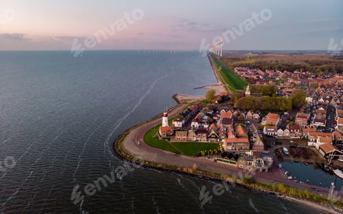 Preview: Urk Flevoland Netherlands sunset at the lighthouse and harbor of Urk Holland. Fishing village Urk
