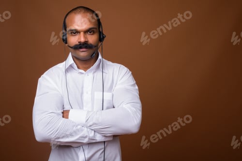 Preview: Portrait of Indian businessman with mustache as call center representative