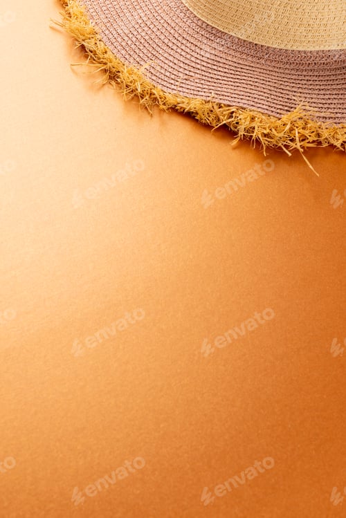 Preview: Vertical image of straw hat on yellow surface