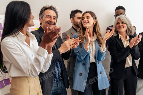 Preview: Enthusiastic multicultural business team celebrating success
