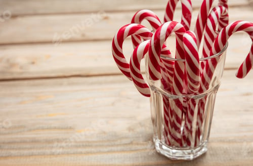 Preview: Candy canes in a glass, wooden background, copy space