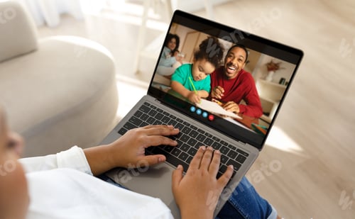 Preview: Mother Video Chatting With Family on Laptop at Home