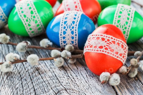 Preview: Easter eggs decorated with lace and willow branch on wooden background. Selective focus
