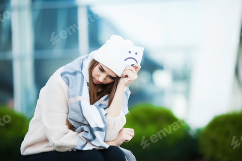 Preview: Woman stressed from work while sitting outdoors