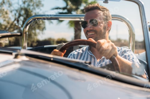 Preview: Man driving a convertible vintage car