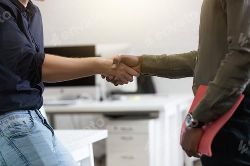 Preview: Close up of two young colleagues shaking hands