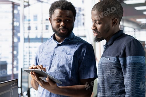 Preview: Teamworking colleagues brainstorming while monitoring company systems