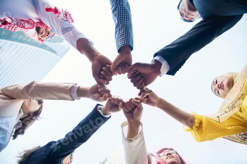 Preview: Multiethnic group of young collaboration team standing hands together . Teamwork Concepts.