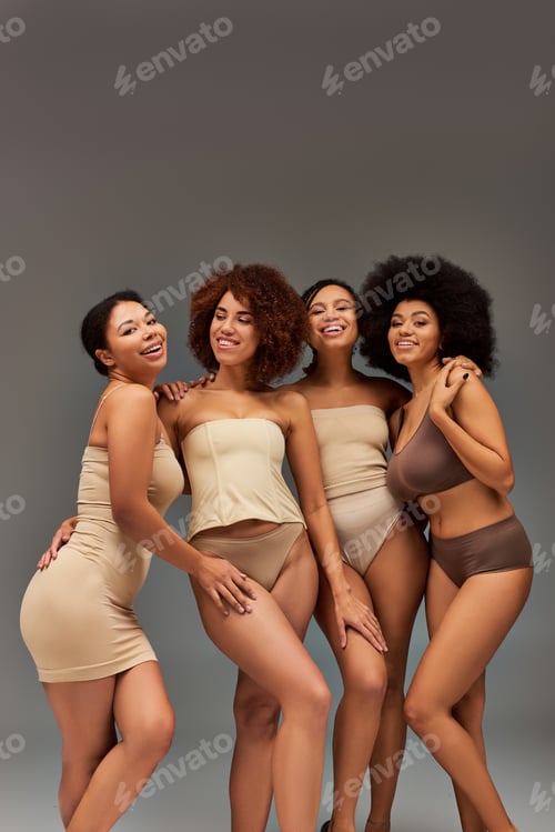 Preview: beautiful cheerful african american women in underwear having great time together, fashion concept