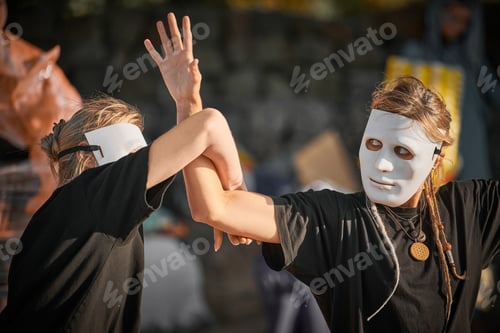 Preview: Two women in white theatre mask dancing on art festival, outdoor art theatrical performance festival