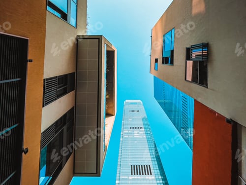 Preview: Low angle shot of modern buildings and skyscapes on a blue sky background