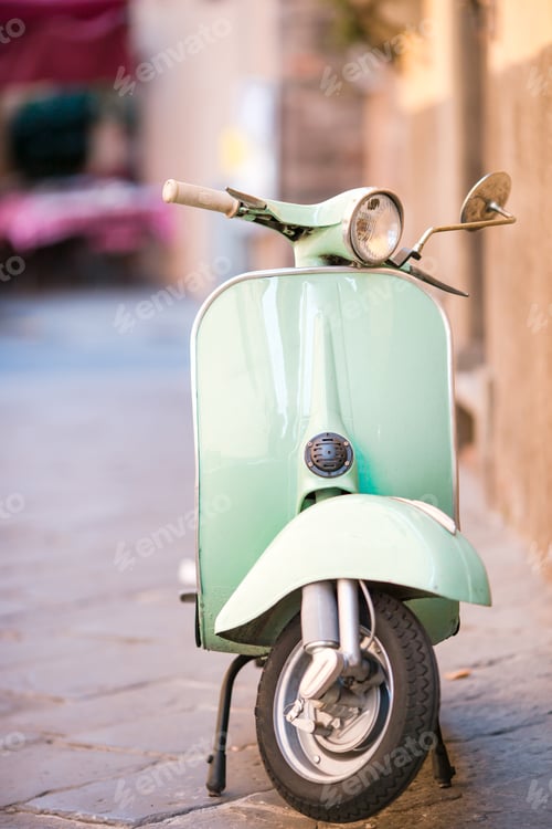 Preview: Light blue scooter on the street of the old city. Old classic european city elements