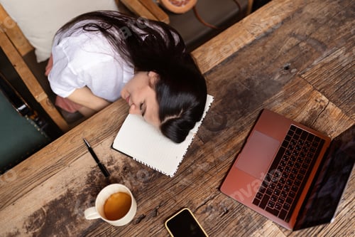 Preview: portrait of tired Young stylish caucasian woman working online on laptop in modern cafe