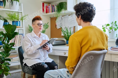 Preview: Female psychologist mental therapist working with young guy in office