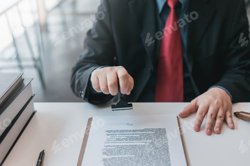 Preview: Businessman stamping with approved stamp on document contract.