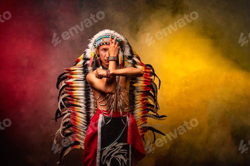 Preview: A man in a red and yellow Indian costume poses with his arms crossed