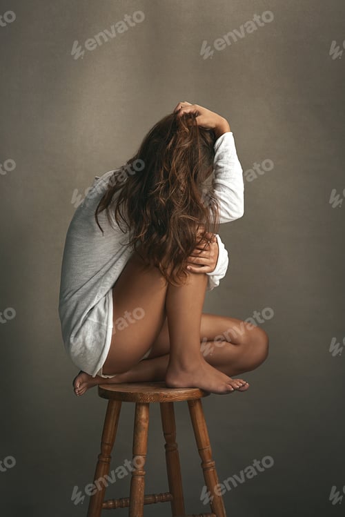Preview: Shot of an unidentifiable young woman posing with her hair in front of her face in studio