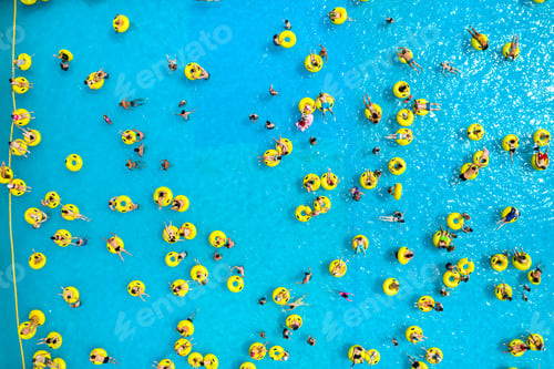 Preview: Top view of People relaxing in the pool on yellow inflatable circles