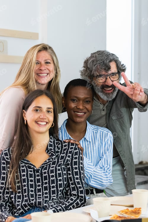 Preview: Cheerful diverse coworking women looking at camera