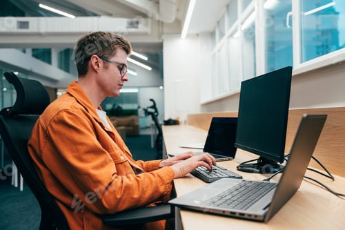 Preview: young programmers working on a new project for a start up business.