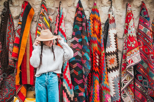 Preview: Old traditional Turkish carpet shop in cave house Cappadocia, Turkey Kapadokya. Young woman on