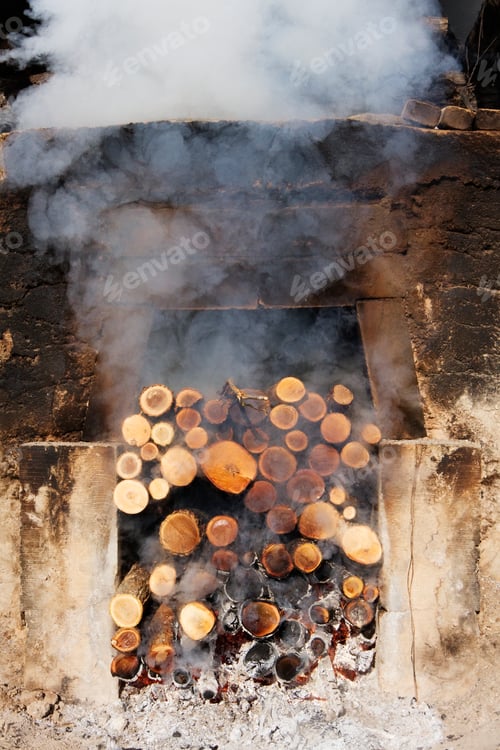 Preview: Smoking pile of logs in open fireplace.