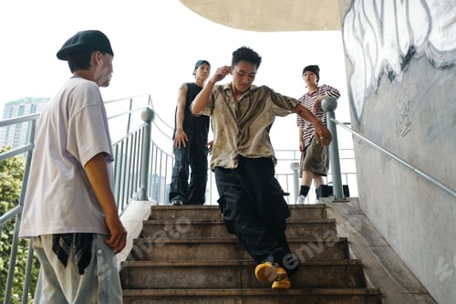 Preview: Teenagers Gathering on Outdoor Stairs in Urban Setting