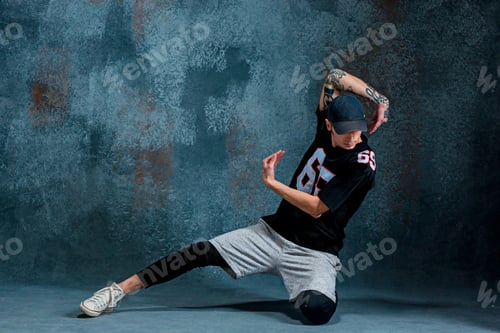 Preview: Young man break dancing on wall background.