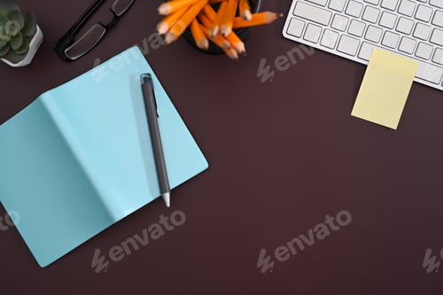 Preview: Creative workplace with notebook, coffee cup and glasses on purple background.