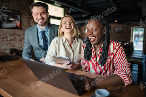 Preview: Diverse business colleagues laughing enjoying casual office meeting