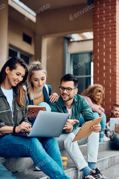Preview: Group of university students e-learning on laptop at campus.