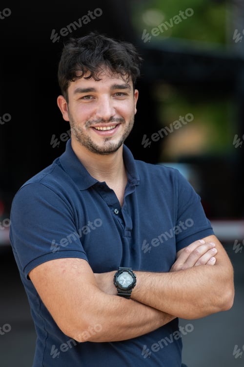 Preview: Portrait of a young successful entrepreneur in front of the company