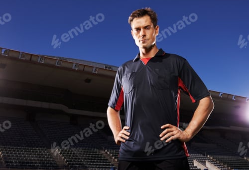 Preview: Confident before the game. A young athlete standing in the stadium lights.