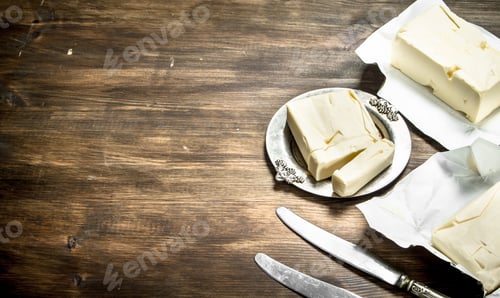 Preview: Blocks of fresh butter on a rustic wooden board