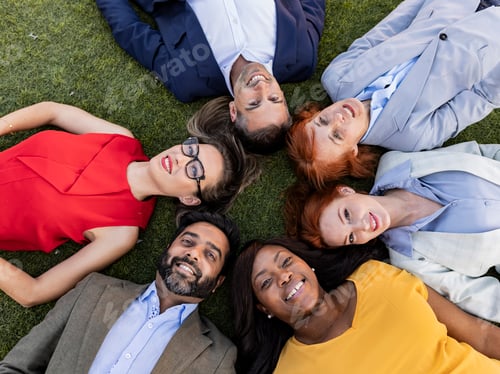 Preview: multiracial business people lying on the grass faces up