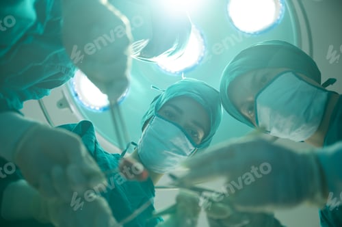 Preview: Medical team of surgeons in hospital doing invasive surgical interventions