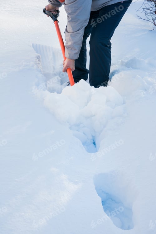 Preview: Man clearing snow by shovel after snowfall. Outdoors.