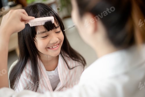 Preview: Girl Smiling While Getting Her Hair Combed