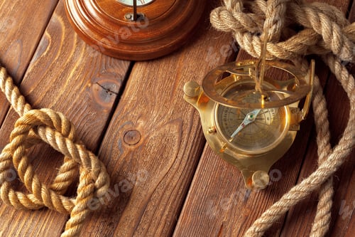 Preview: Compass and rope on wooden table. close up